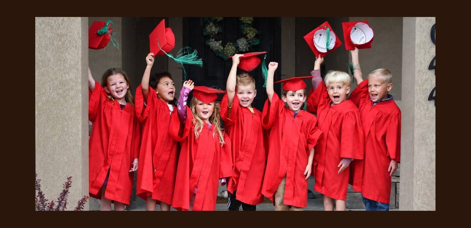 Apple Academy Preschool graduates tossing their caps in the air